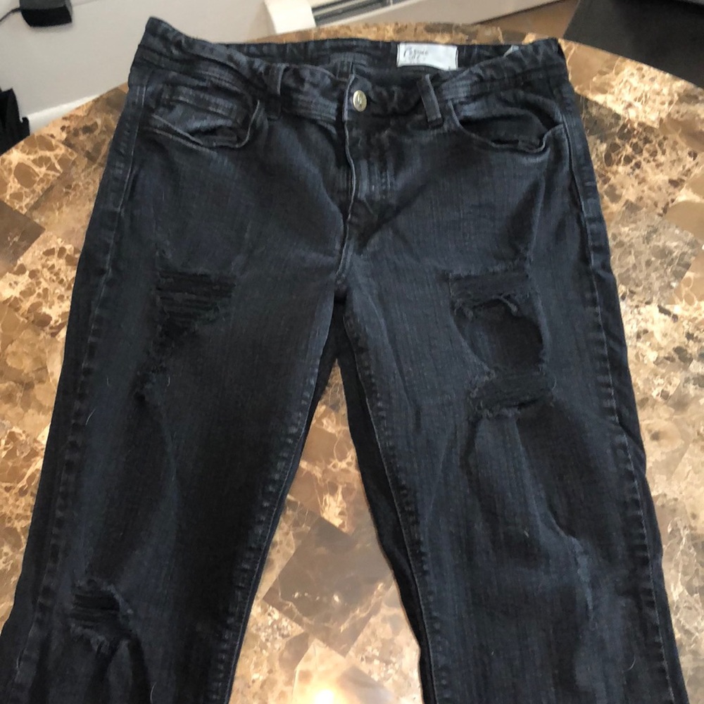Distressed black skinny jeans